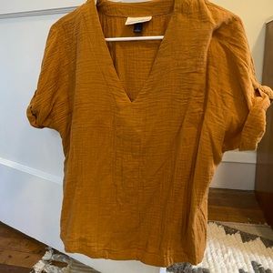 Only worn one. Cute orange shirt.